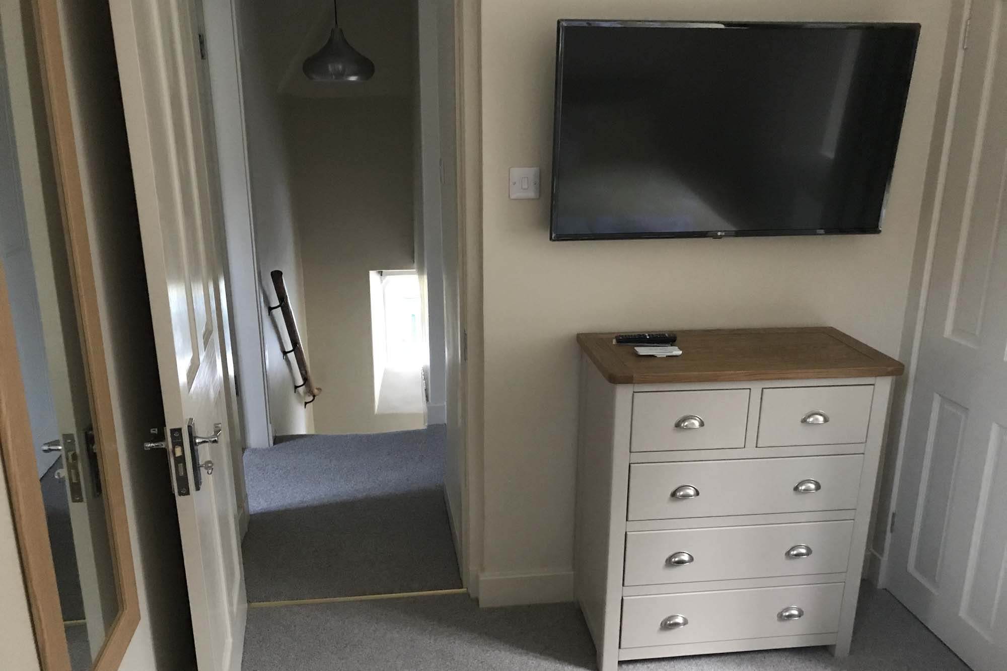 storage and tv in double bedroom